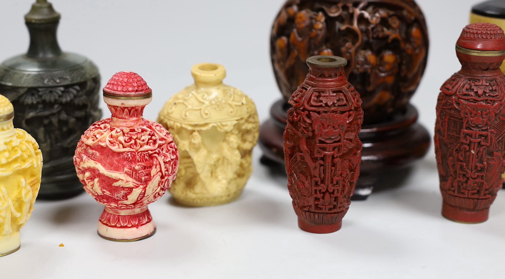 A large Chinese 20th century carved snuff bottle and smaller snuff bottles, all resin